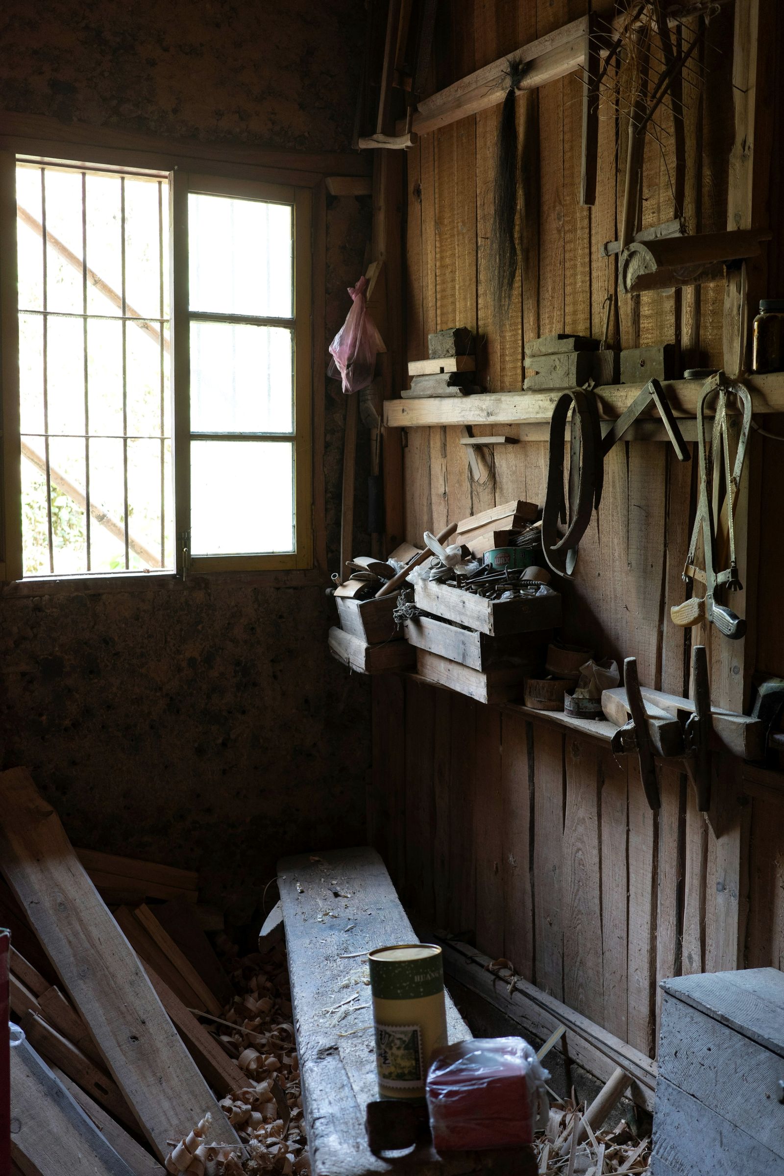 Daylight falling across a long-established workshop, its tools hung neatly on the walls