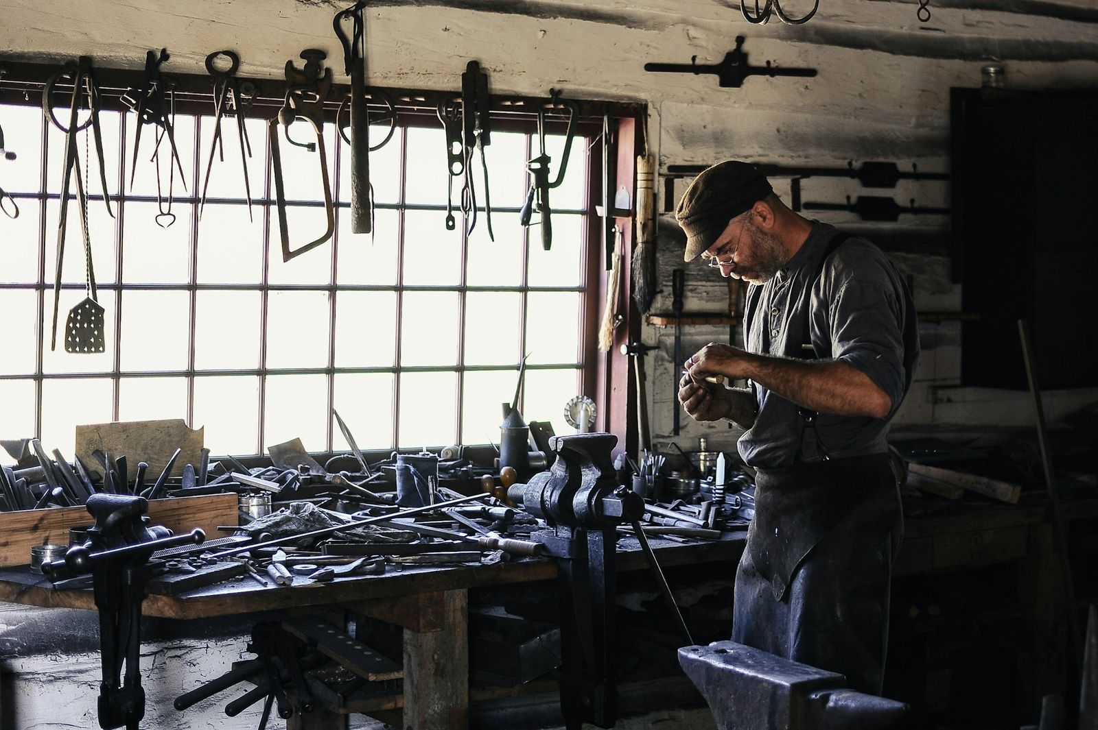 A craftsman at work at his bench in a long-established metal workshop