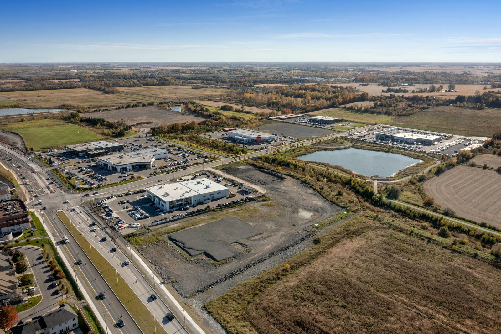 An aerial view of business park buildings surrounded by open farmland