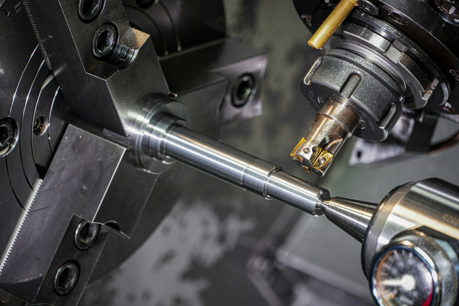 A steel shaft being precision-turned on a lathe