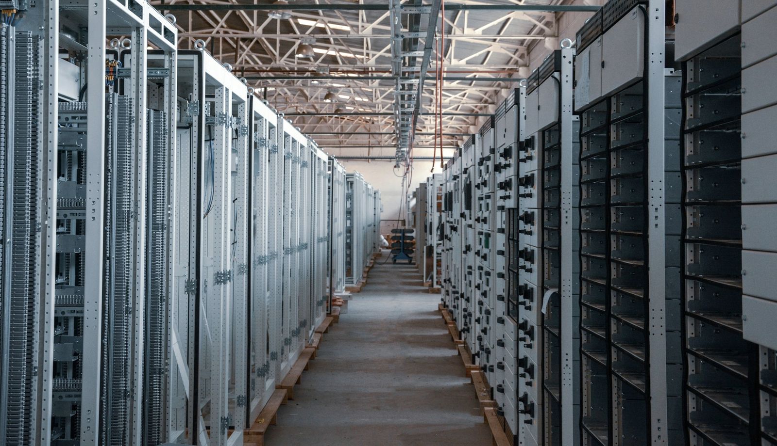 A long aisle of equipment racks in a data centre